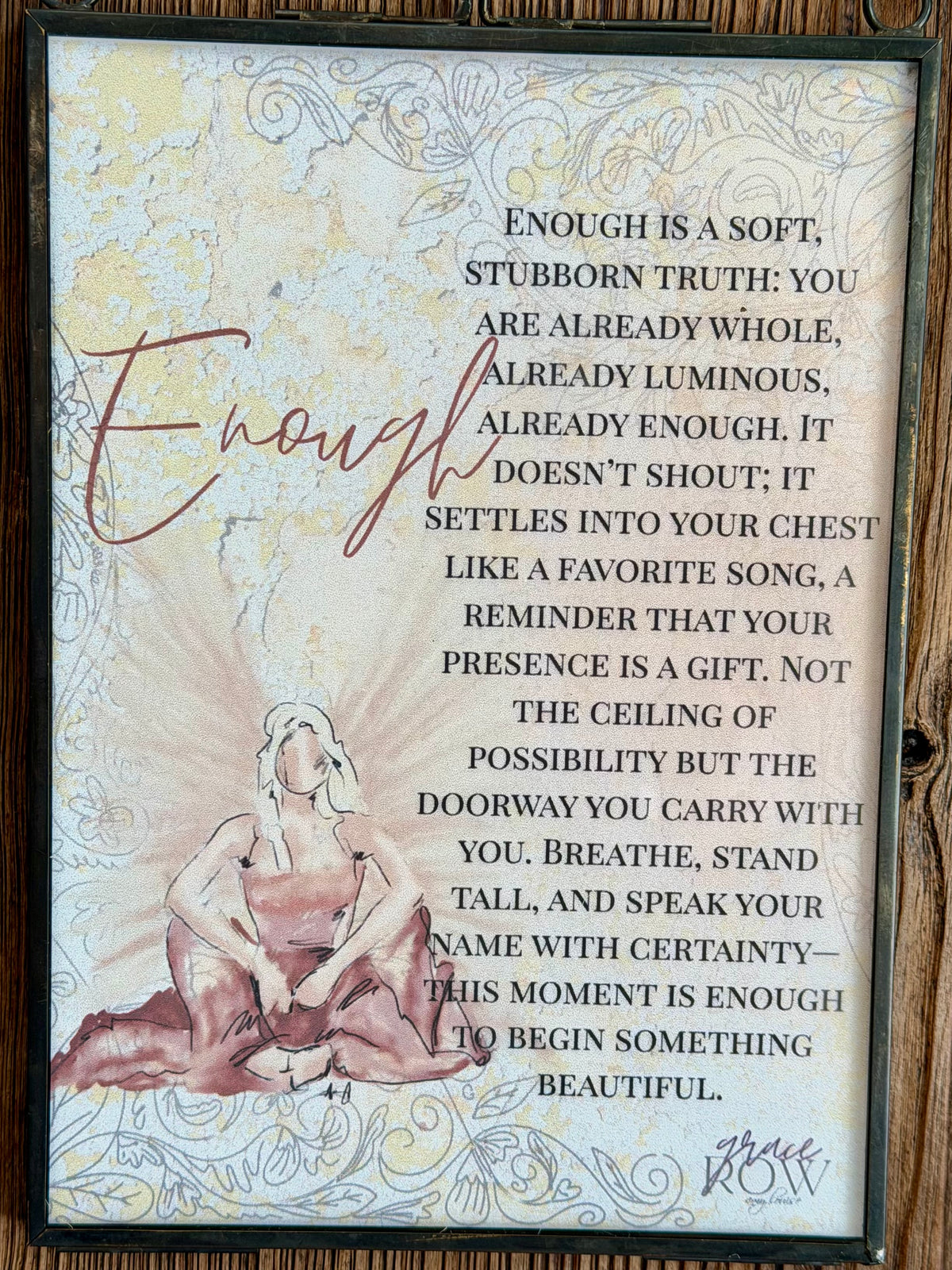 Decorative wall art with a quote and a woman's silhouette on a wooden background