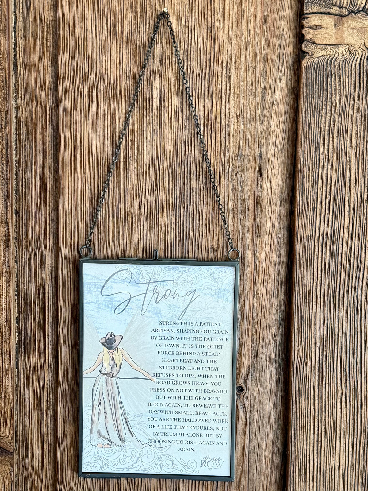 Decorative sign with motivational text and illustration on a wooden background