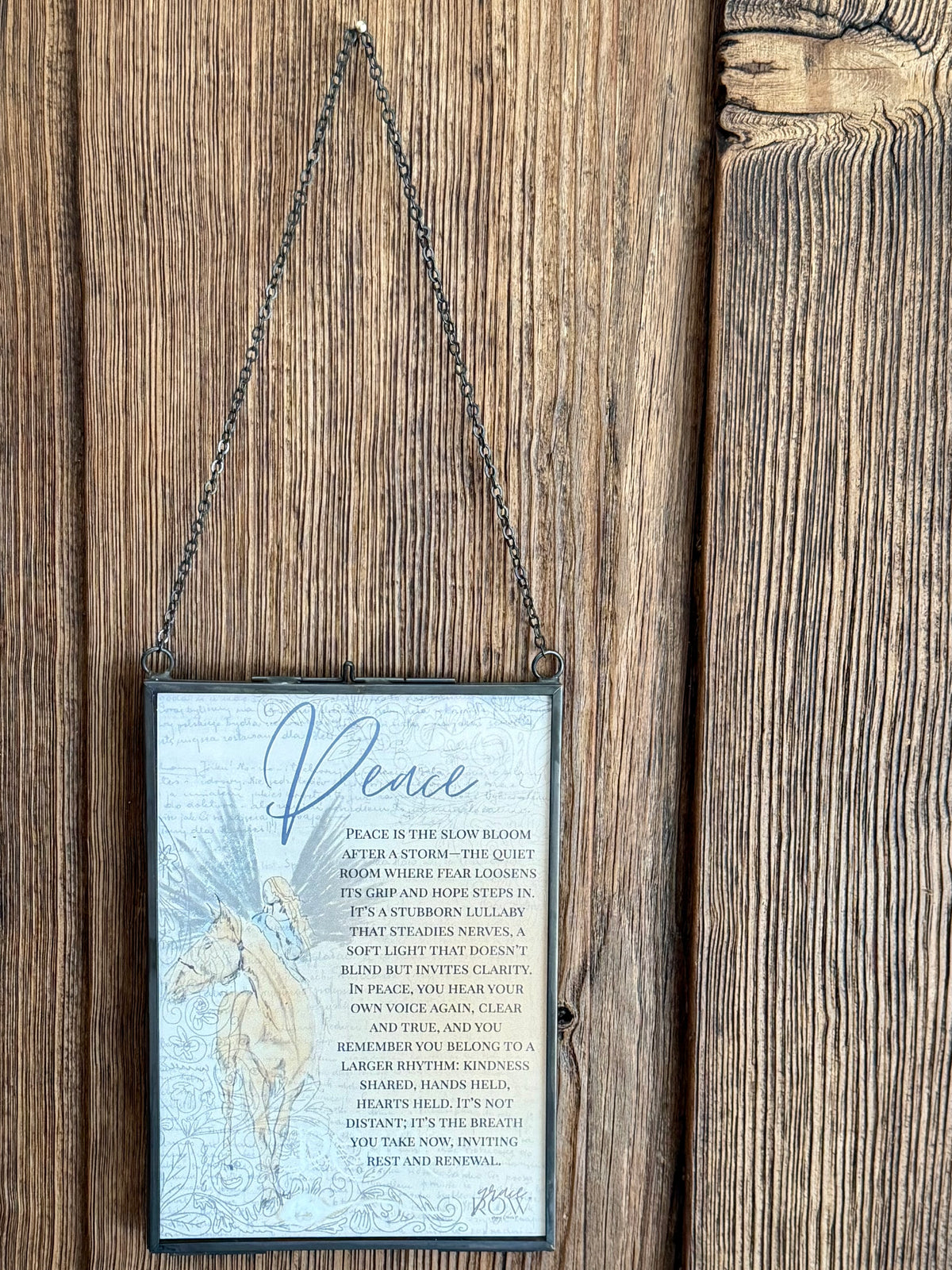 Decorative sign with text and a horse illustration hanging on a wooden door.