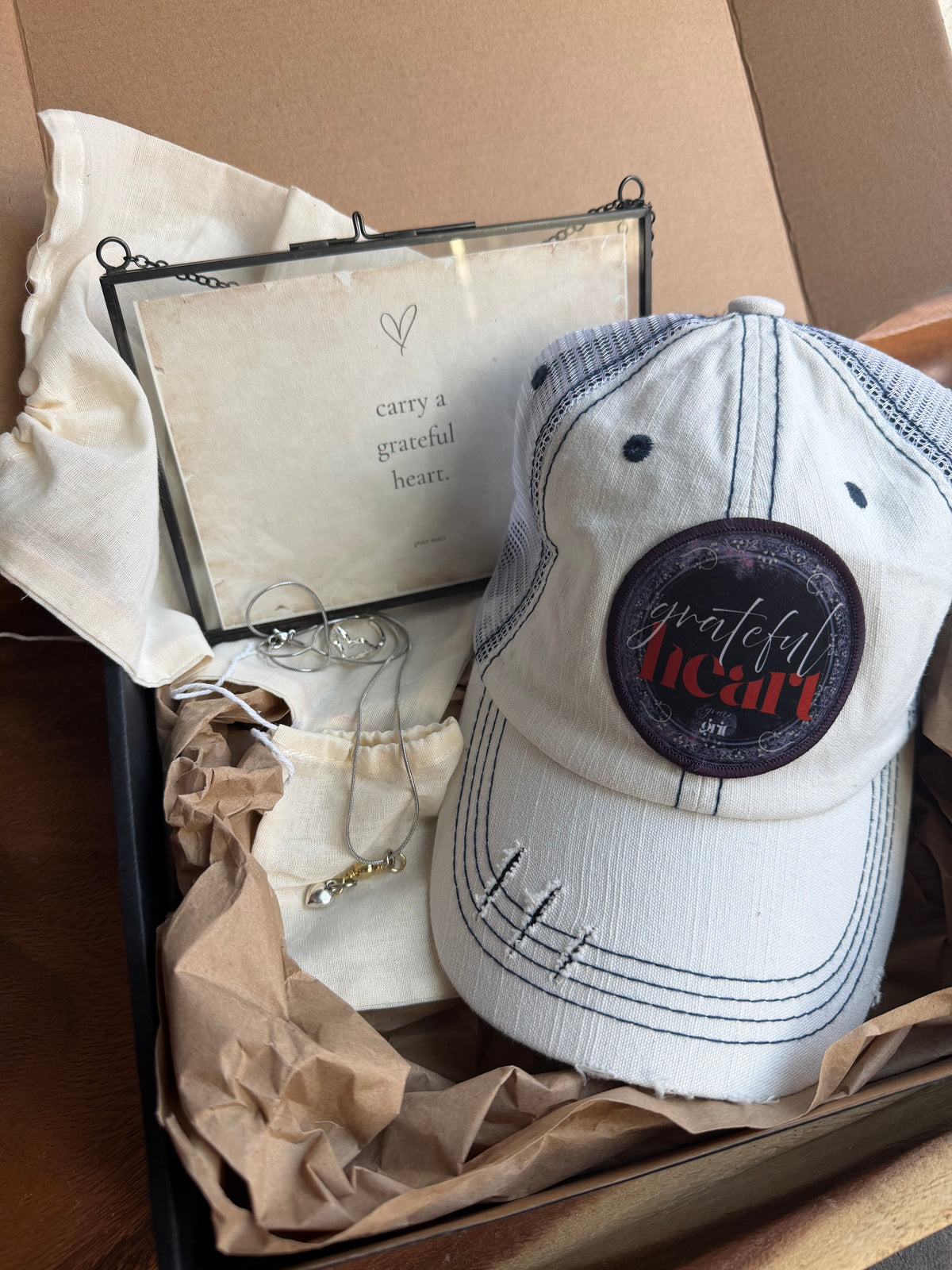 White cap with a logo in an open box